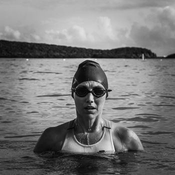 Portrait of woman swimming in sea against sky