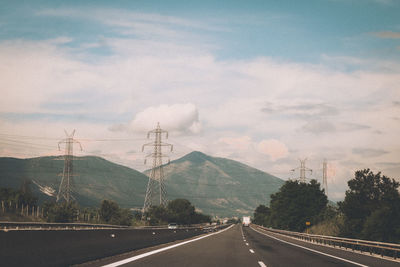 Road by mountain against sky