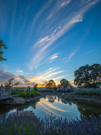 Scenic view of lake against sky at sunset