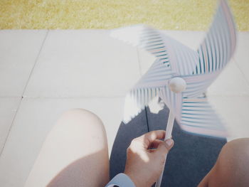 High angle view of hand holding pinwheel toy