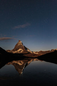 Scenic view of mountains against sky at night