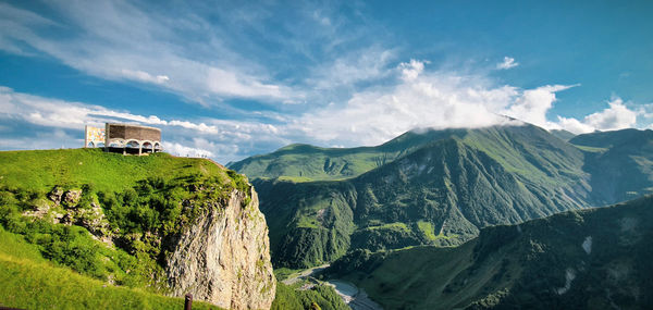 Panoramic view of building and mountains against sky