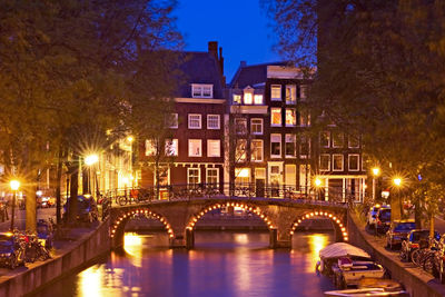 View of bridge over canal at night