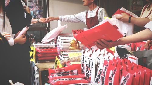 People for sale at market stall