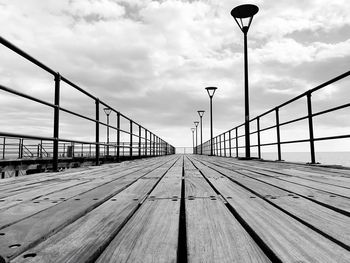 Surface level of pier on bridge against sky