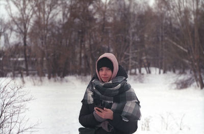 Portrait of woman standing in snow