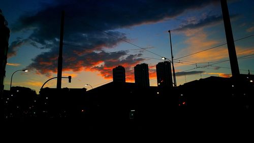 Low angle view of silhouette city against sky during sunset
