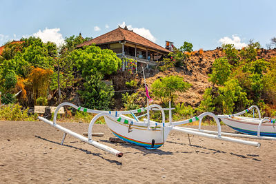 Gazebo on beach by building against sky