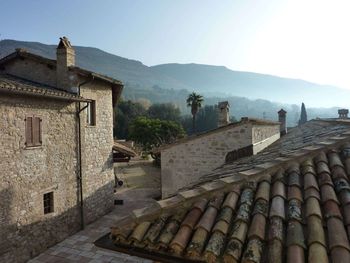 Scenic view of mountain seen from rooftop against sky