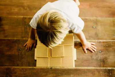 Rear view of cute girl on floor