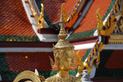 Low angle view of statue against temple