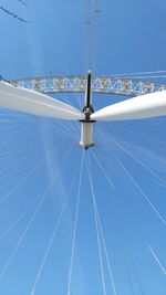 Low angle view of ferris wheel against clear blue sky