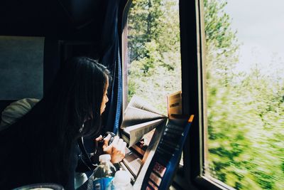 Close-up of woman sitting in train