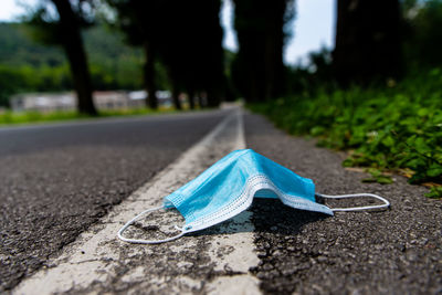 Close-up of blue umbrella on road