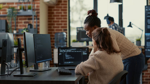 Computer programmers brainstorming at office