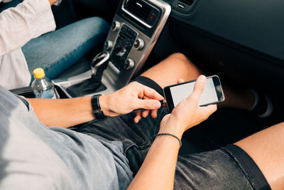 High angle view of man charging smart phone in car