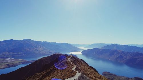 High angle view of river and mountains against clear sky