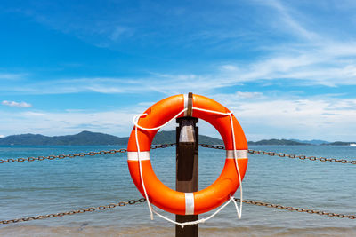 View of wooden post in sea against sky