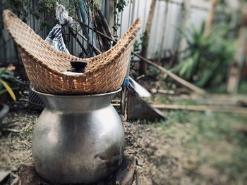 Close-up of old wicker basket on field