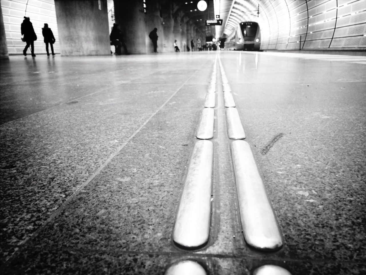 men, walking, lifestyles, person, transportation, indoors, unrecognizable person, the way forward, leisure activity, street, city life, incidental people, rear view, low section, tiled floor, road marking, full length, road