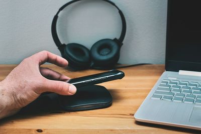 Midsection of woman using laptop on table