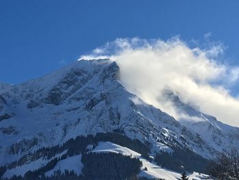 Scenic view of snowcapped mountains against clear blue sky