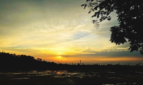 Scenic view of silhouette trees against sky during sunset