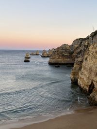 Scenic view of sea against clear sky during sunset