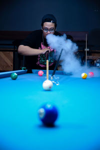 Portrait of woman playing pool