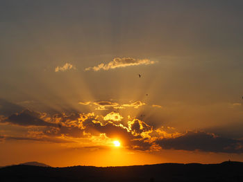 Scenic view of silhouette mountains against sky during sunset