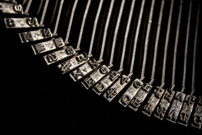 Cropped image of typewriter on black background