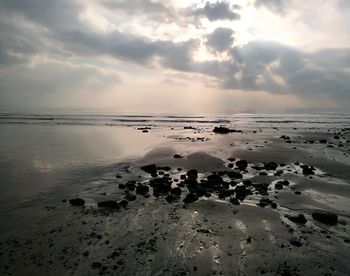 Scenic view of beach against sky during sunset