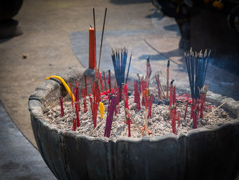 Close-up of burning candles in temple