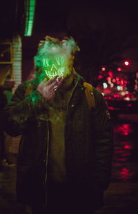 Digital composite image of man and christmas lights