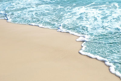 High angle view of waves rushing towards shore