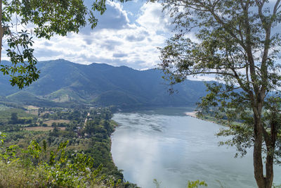 Scenic view of sea and mountains against sky