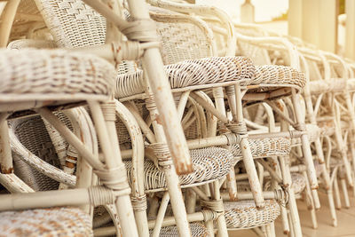 Close-up of stacked wicker chairs on floor