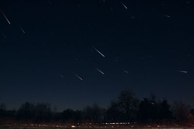 Scenic view of field against sky at night
