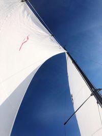 Low angle view of mast against blue sky during sunny day