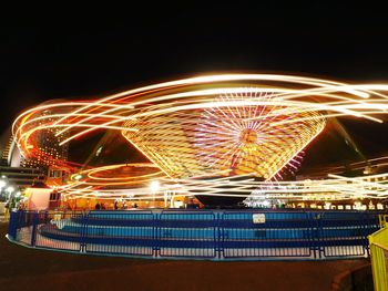 Low angle view of light trails at night