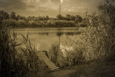 Scenic view of lake against sky at sunset