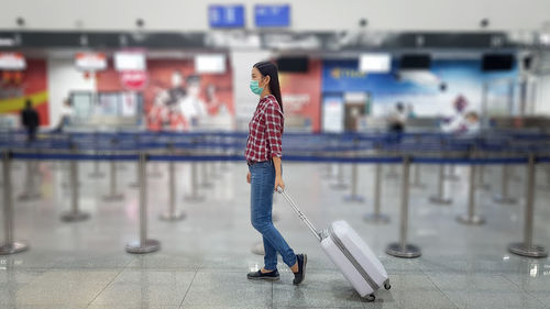 Portrait of woman standing at airport