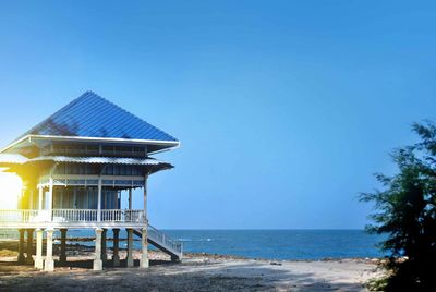 Built structure on beach against clear sky