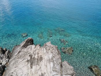 High angle view of rocks by sea