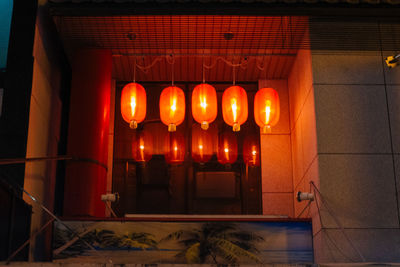 Illuminated lanterns hanging in building