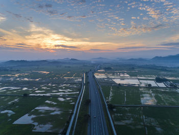 Aerial view of city against sky during sunset