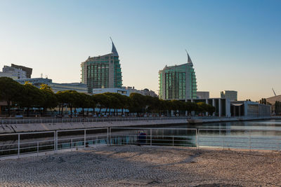 View of buildings in city against clear sky