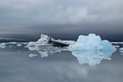 Scenic view of frozen sea against cloudy sky