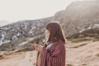 Side view of woman wrapped in shawl