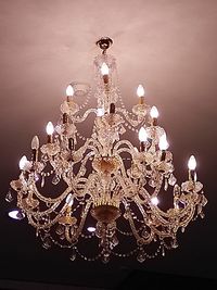 Low angle view of illuminated chandelier hanging from ceiling